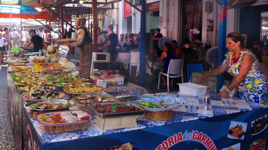 Una vibrante escena de mercado al aire libre con una mesa llena de diversos platos y ensaladas de colores. Una mujer con un vestido de flores está junto a la comida, mientras la gente cena y pasea en el bullicioso fondo bajo toldos.